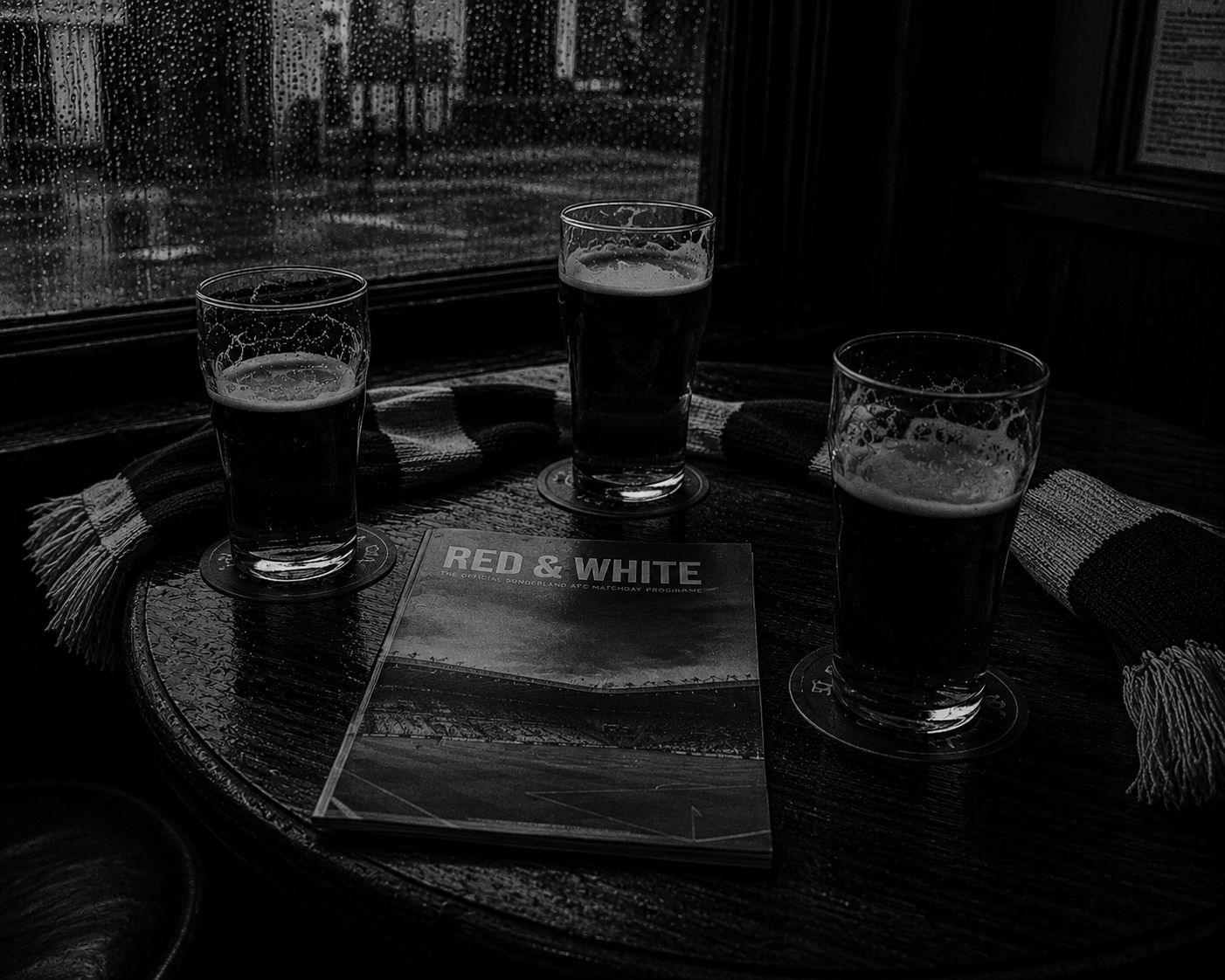 Pints and match programme on a pub table